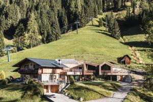 a house on the side of a hill at Borgo Antico Mountain Lodge in Sappada