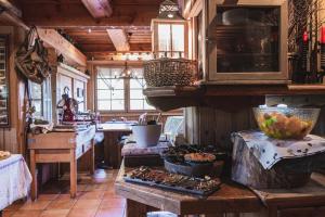 a kitchen with a counter with food on it at Chalet Hôtel & Spa Le Collet in Xonrupt-Longemer