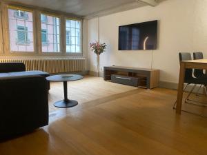 a living room with a couch and a table at Appartment floor 1 in Thun