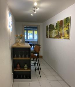 a living room with a table and a chair at Appartment floor 1 in Thun