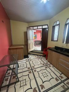 a living room with a tile floor and a sink at Casa Altos JM in Ananindeua