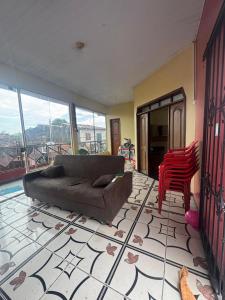 a living room with a couch and a red chair at Casa Altos JM in Ananindeua