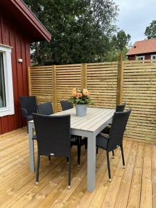 a table and chairs on a wooden deck at Cozy guesthouse in Vallda in Vallda