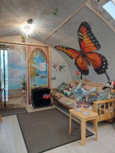 a living room with a butterfly mural on the wall at Butterfly PODika in Lerwick +24 photos
