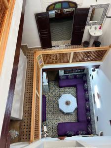 an overhead view of a room with a table and an umbrella at DarMouniaFès in Fez +17 photos