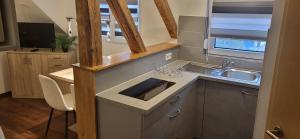 a kitchen with a sink and a counter top at Ferienwohnung Jasmin in Rust +25 photos