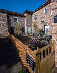 a wooden fence in front of a brick building at Willow Studio in Telford