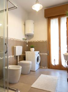 a bathroom with a washing machine and a washer and dryer at Lizard Residence in Lido di Jesolo +12 photos