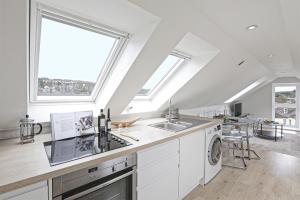 a kitchen with a sink and a dishwasher at The Loft modern flat in the heart of Wadebridge in Wadebridge +10 photos