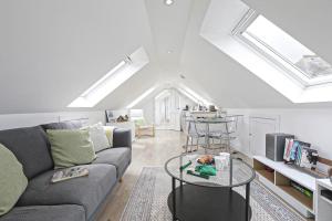 a living room with a couch and a table at The Loft modern flat in the heart of Wadebridge in Wadebridge