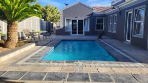 a swimming pool in the backyard of a house at Frankie's Nest in Cape Town