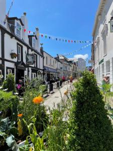a street with flowers and plants on a city street at The Loft modern flat in the heart of Wadebridge in Wadebridge