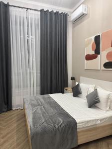 a bedroom with a large bed and a window at Five Hotel in Astana +5 photos