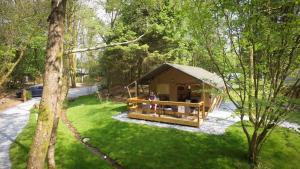 a person sitting in a tent in the grass at Blencathra - Safari Tent in Ambleside +6 photos
