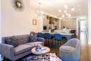 a living room with a couch and a table with chairs at Hello Again, Chicago! in Chicago
