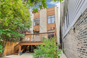 a house with a wooden deck on the side of it at Hello Again, Chicago! in Chicago