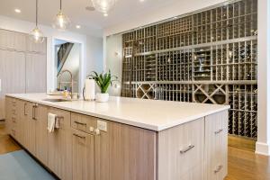 a kitchen with a wine cellar with a large island at Hello Again, Chicago! in Chicago +103 photos