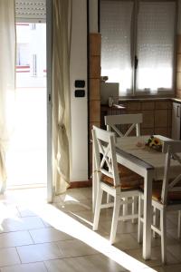 a kitchen with a white table and chairs at Situation House in Catanzaro Lido