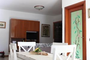 a dining room with white chairs and a table at Situation House in Catanzaro Lido