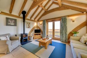 a living room with a couch and a wood stove at 2 Bed in Tenterden oc-tn606 in Stone