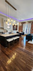 a kitchen and living room with a counter and a dining room at The Luxe Building- 2 Bedroom Apartment in Metropolis in Metropolis