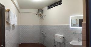 a bathroom with a toilet and a sink at Eyana Residency in Lāitlyngkot