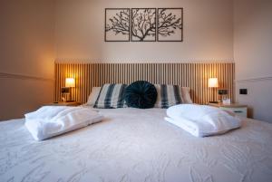 a white bed with two pillows on top of it at Hambledon Hotel in Shanklin
