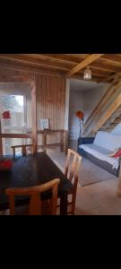 a room with a table and chairs and a bed at Portal de maria in Imbituba
