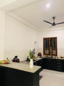 a kitchen with a vase of flowers on a counter at Liya Villa in Ahangama +11 photos