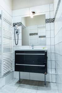 a bathroom with a sink and a mirror at La Ferme de la Gronde in Magny-en-Bessin +70 photos