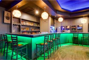 a green bar with stools in a room at Motel 6 Kerrobert, SK in Kerrobert