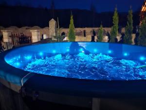 a large blue hot tub with blue lights on it at Sloneczna Osada 2 in Kowary