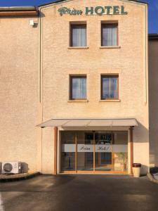 a large brick building with a hotel sign on it at Contact Hôtel - Prim Witry - Reims Nord in Reims
