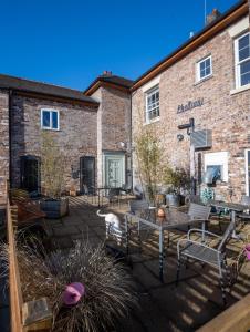 a patio in front of a brick building at The Alder Studio @ The Pheasant in Telford