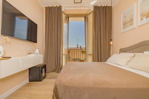 a hotel room with a bed and a large window at Visconti Apartment by Rhospitality it in Rho