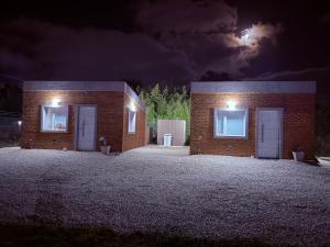 a brick building with two doors at night at Freedom in Miramar