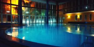 a large swimming pool in a building at The Yerbal Thermal House in Termas de Guaviyú