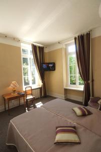 a bedroom with a large bed and two windows at Logis Hotel la Résidence in Le Val-dʼAjol +35 photos
