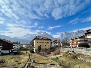 a view of a city with mountains in the background at The Cozy Peak - 360 Dolomites View in Agordo