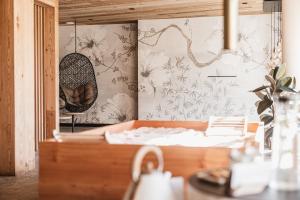 a room with a bed and a mirror at Borgo Antico Mountain Lodge in Sappada +18 photos