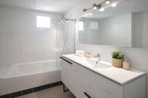 a white bathroom with a sink and a bath tub at Noctua Manilva Sea View 023 in Manilva +4 photos
