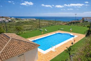 an overhead view of a swimming pool with the ocean at Noctua Manilva Sea View 023 in Manilva