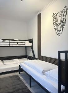 two bunk beds in a room with a wall at Zemlinsky Loft Bunk Room in Payerbach