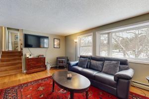 a living room with a couch and a table at White Mountain Trailhead in Campton