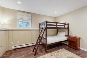 a bedroom with a bunk bed with a ladder at White Mountain Trailhead in Campton