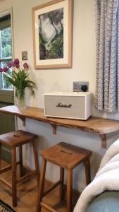 a table with a microwave on top of it at Seaside Shepherd's Hut in Mundesley