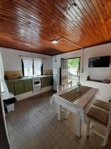 a kitchen with a wooden ceiling and a wooden table at Ave del Paraíso in Colón