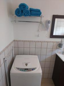 a washing machine in a bathroom with blue towels at Ushuaia centro Complejo de Cabañas in Ushuaia +27 photos