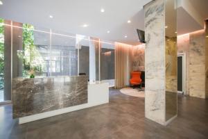an office with a lobby with a stone wall at TheROOMS by TheFLOOR Collection in Milan