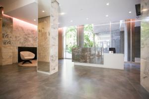 a lobby with a fireplace and a chair at TheROOMS by TheFLOOR Collection in Milan